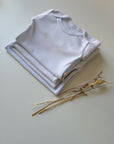 LOT 4 BODIES BLANCS BÉBÉ – MANCHES LONGUES – PRESSIONS PRATIQUES – DÈS 1 MOIS